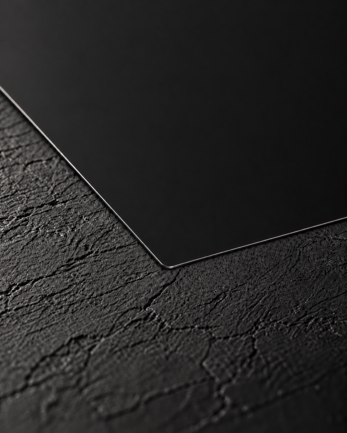 Matte black aluminum card showing its thin metallic edge